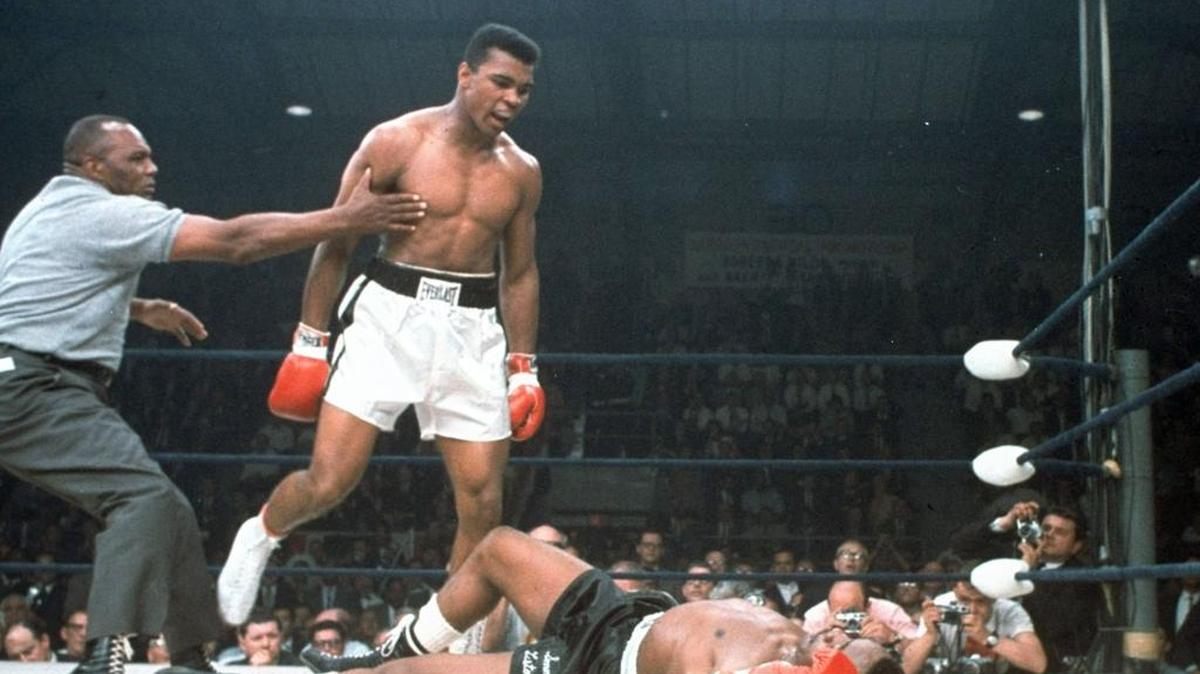 Heavyweight champion Muhammad Ali is held back by referee Joe Walcott after Ali knocked out challenger Sonny Liston in the first round of their title fight May 25, 1965, in Lewiston, Maine. Ali, the magnificent heavyweight champion whose fast fists and irrepressible personality transcended sports and captivated the world, has died according to a statement released by his family Friday, June 3, 2016. He was 74.