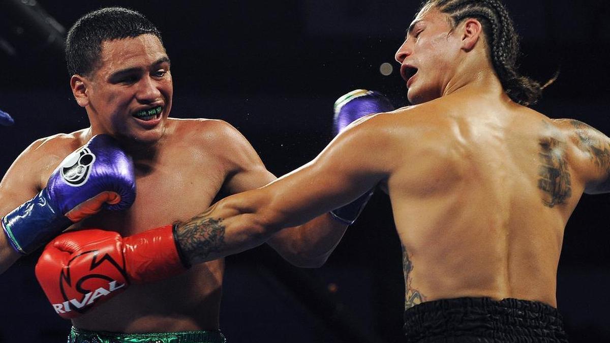 Gabriel Flores, Jr., left, lands a punch on James De Herrera, right, in their lightweight bout at the Protecting Home: Jose Ramirez event, a Top Rank night of boxing July 7, 2018 at Save Mart Center in Fresno.