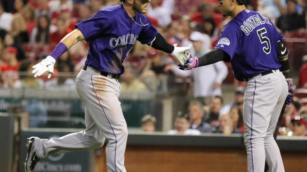 Colorado rookie Trevor Story, left, celebrates one of his home runs with teammate Carlos Gonzalez in Cincinnati on April 18, 2016.
