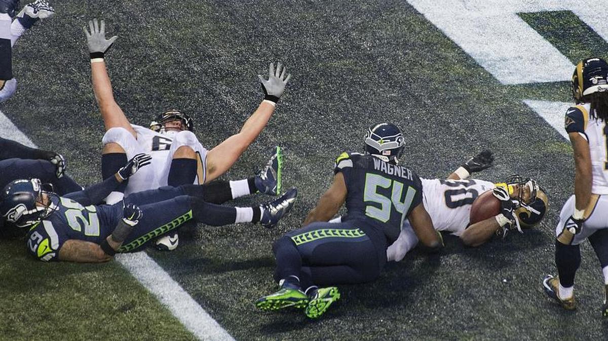 Rams lineman Cody Wichmann raises his hands to celebrate teammate Todd Gurley scoring what proved to be the game-deciding TD in the second half Sunday, Dec. 27, 2015.