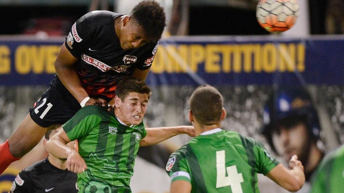 Fresno Fuego forward Christian Chaney heads the ball over Burlingame’s Drew Skundrich in a Premier Development League playoff match Tuesday, July 19, 2016, at Chukchansi Park. Chaney, a Fresno native, will again call the Chuk home as one of the latest players to sign with USL expansion club Fresno FC.