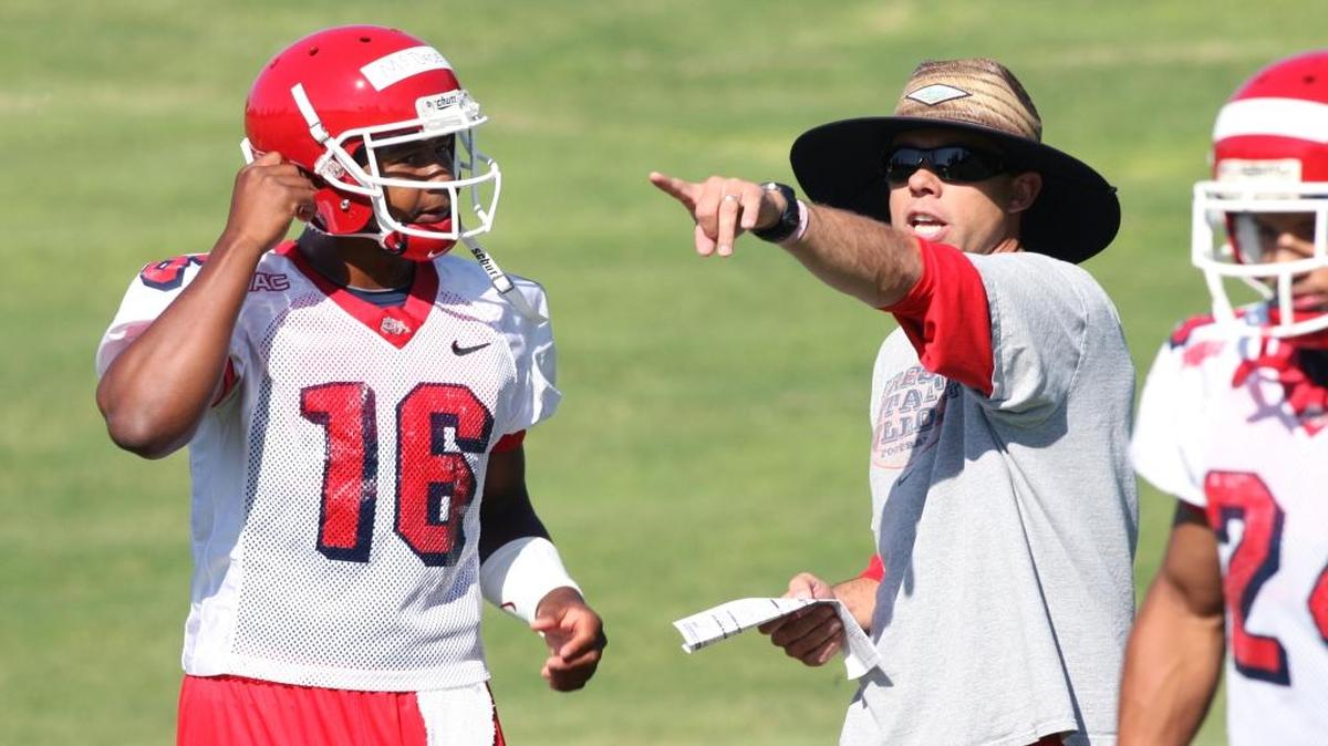 Ex-Fresno State quarterbacks coach Jeff Grady works with Fresno State QB Marcus McDade on the first day of practice, Thursday morning, Aug. 4, 2011. Grady was presented a $1,000 check from former Bulldogs’ Kenny Wiggins for being the Chargers’ Coach of the Week.