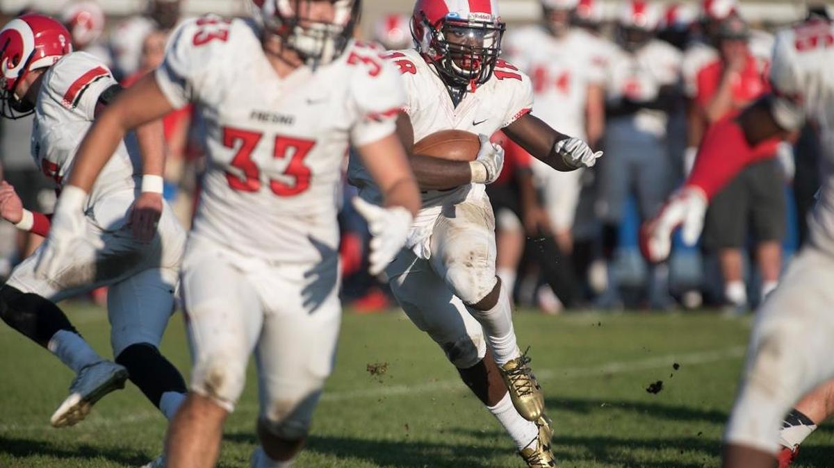 Fresno City College running back Nate Jones breaks out for a fourth-quarter touchdown against Modesto during a Valley Conference game Saturday. Jones had four TDs in all in the Rams’ 55-42 win.