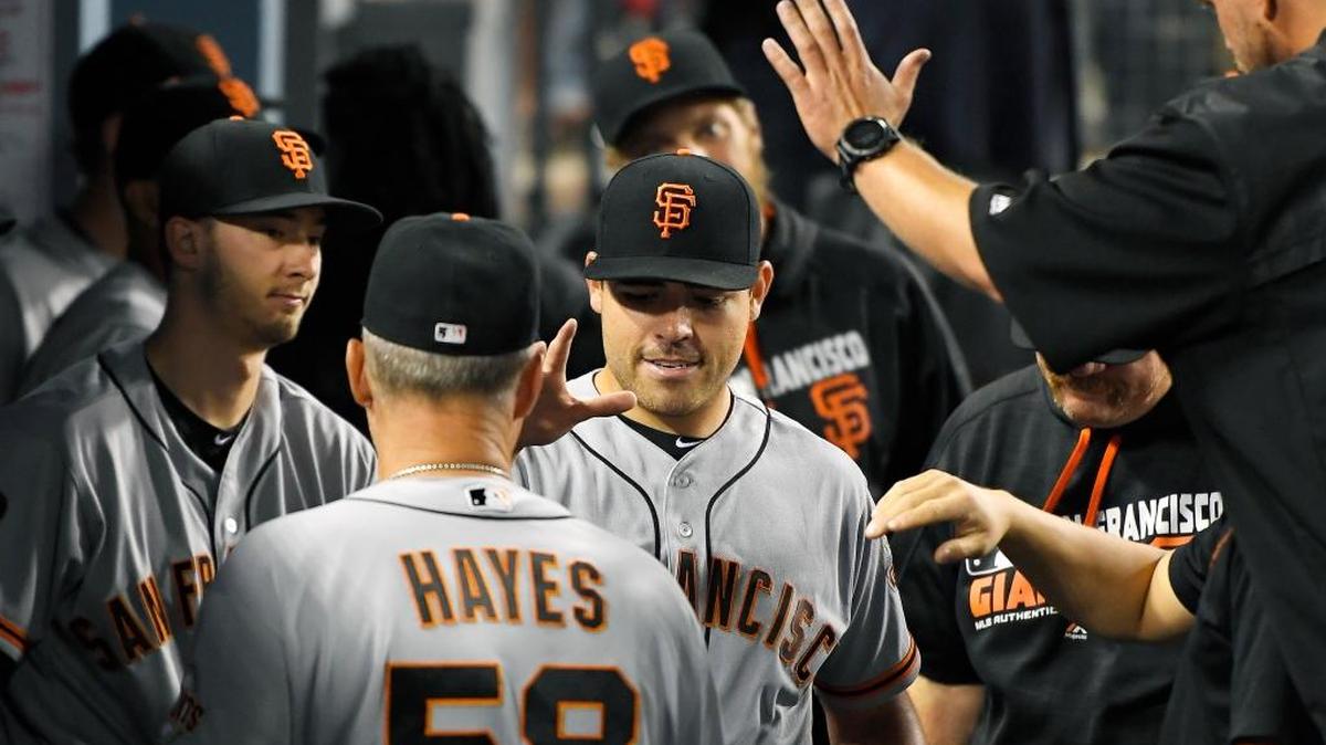 Giants starting pitcher Matt Moore, center, is congratulated by teammates after being taken out of the game with two outs in the ninth inning against the Los Angeles Dodgers on Thursday, Aug. 25, 2016, in Los Angeles. Moore had a no-hitter going until he gave up a single to Corey Seager.