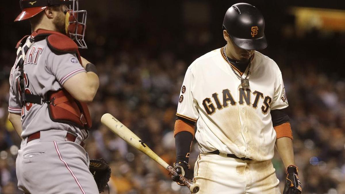 The San Francisco Giants’ Ramiro Pena, right, reacts after striking out as Cincinnati Reds catcher Tucker Barnhart looks on during the ninth inning of a baseball game, Monday, July 25, 2016 in San Francisco. The Reds won 7-5, handing the Giants their eighth loss in their first nine games following the All-Star break.