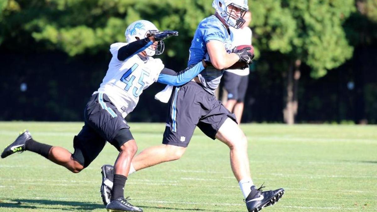 Former Fresno State star Charles Washington, left, attempts to knock the ball out during a recent practice at the Detroit Lions training camp.