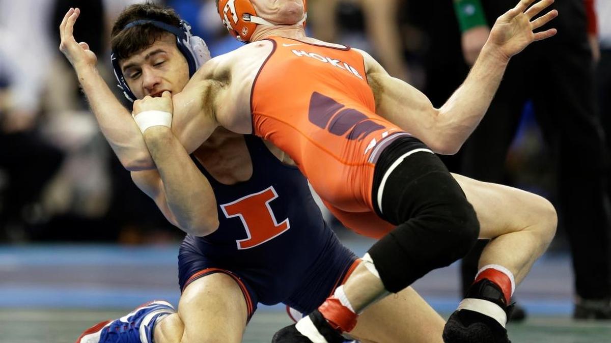 Illinois’ Isaiah Martinez takes control of Virginia Tech’s Nick Brascetta in a 157-pound quarterfinal at the NCAA Division I championship Friday in New York. Martinez won 6-3, topped Kent State’s Ian Miller with a 7-5 sudden victory in overtime in the semifinal and will look to complete his bid for back-to-back national championships when he faces Jason Nolf of Penn State on Saturday.