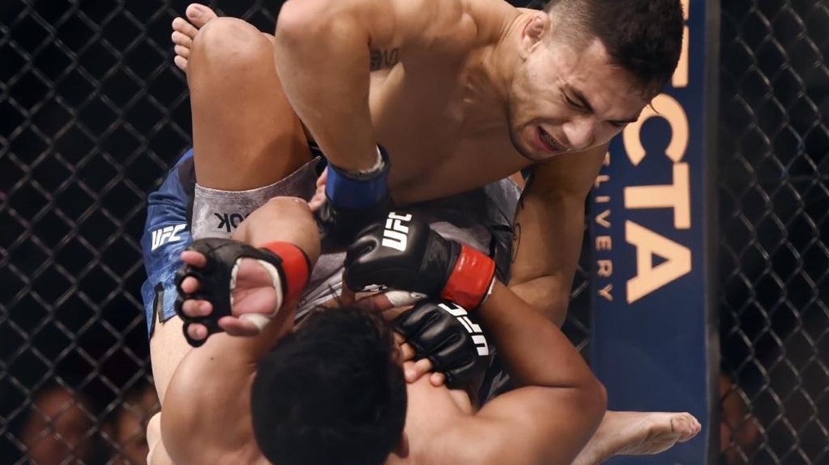 Lemoore’s Alex Perez, top, is seen in his Dec. 9, 2017, bout versus Carls John de Tomas en route to Perez winning his UFC debut at Fight Night 123 at Fresno’s Save Mart Center.