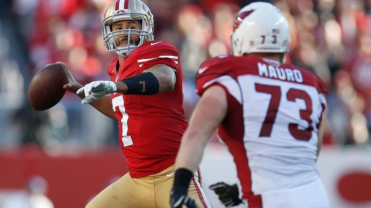 San Francisco 49ers quarterback Colin Kaepernick (7) passes as Arizona Cardinals defensive end Josh Mauro (73) applies pressure during the second quarter of an NFL football game in Santa Clara, Calif., Sunday, Dec. 28, 2014.