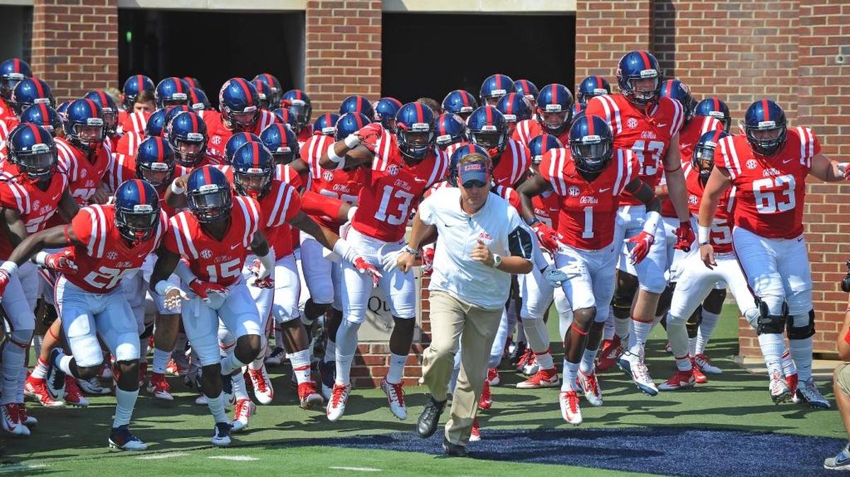 
Mississippi coach Hugh Freeze leads players on the field ahead of their season opening game against Tennessee-Martin on Saturday in Oxford, Miss.
