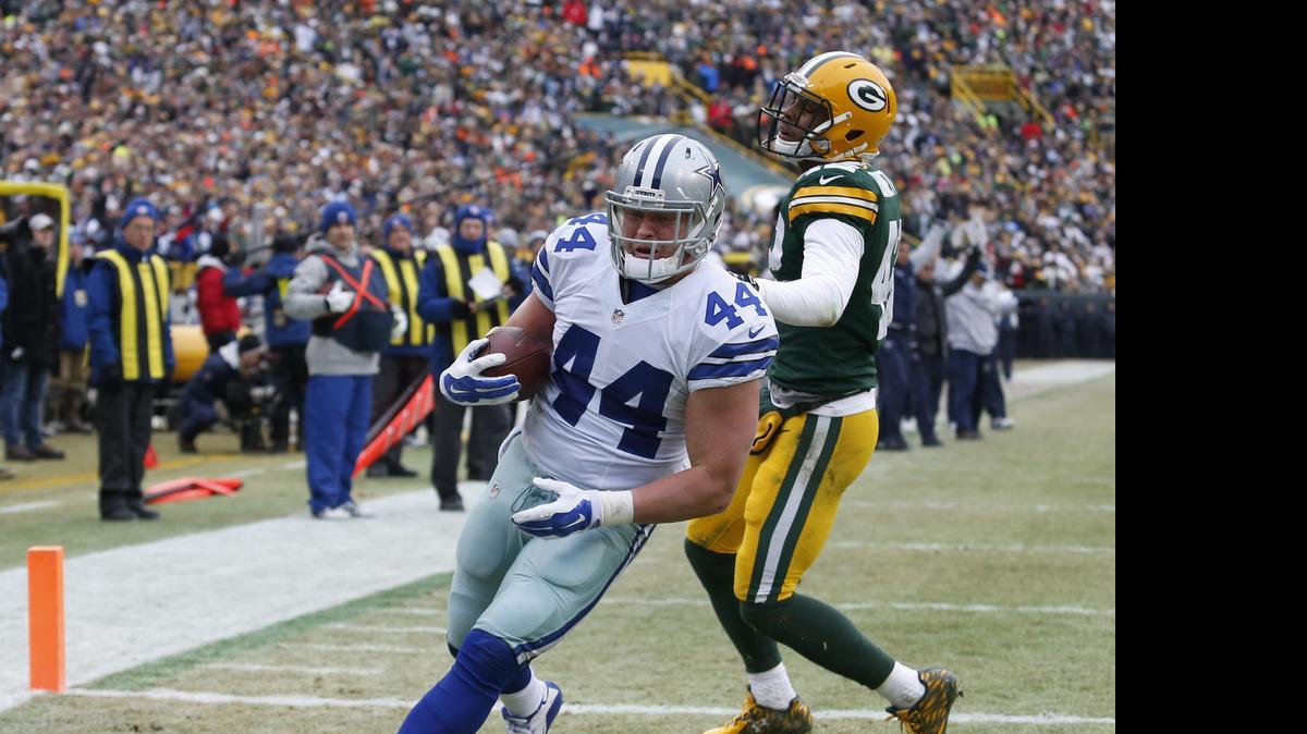 
Dallas Cowboys fullback Tyler Clutts runs into the end zone to score on a 1-yard touchdown pass during the first half of an NFL divisional playoff football game against the Green Bay Packersn on Jan. 11, 2015. Clutts is back for his third season with the Cowboys.

