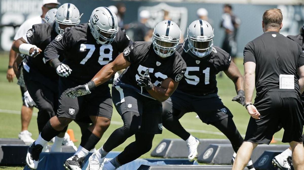 From left, Oakland Raiders defensive tackle Justin Ellis (78), defensive end Khalil Mack, and offensive linebacker Bruce Irvin take part in a drill during their football minicamp Tuesday, June 14, 2016, in Alameda, Calif. The Raiders open training camp Friday, July 29, in Alameda.