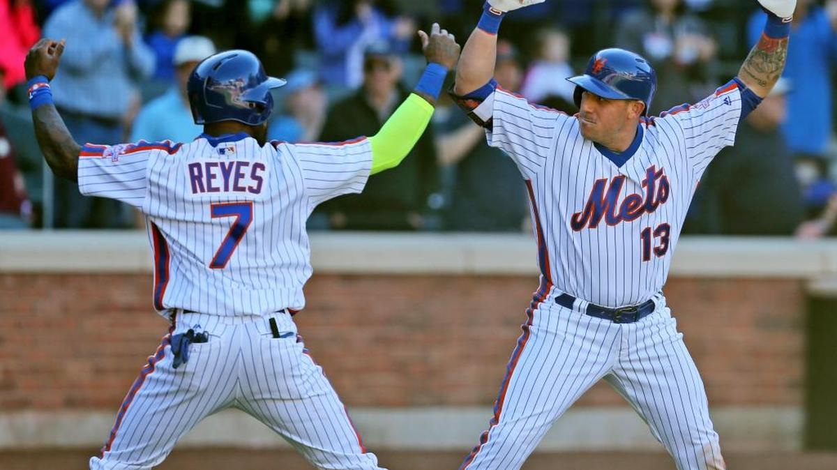 New York Mets infielder Asdrubal Cabrera celebrates his grand slam with Jose Reyes during the seventh inning of a baseball game against the Philadelphia Phillies at Citi Field on Sunday, Sept. 25, 2016 in New York. The Mets won 17-0 and moved a game ahead of the San Francisco Giants for the top spot in the National League wild-card race.