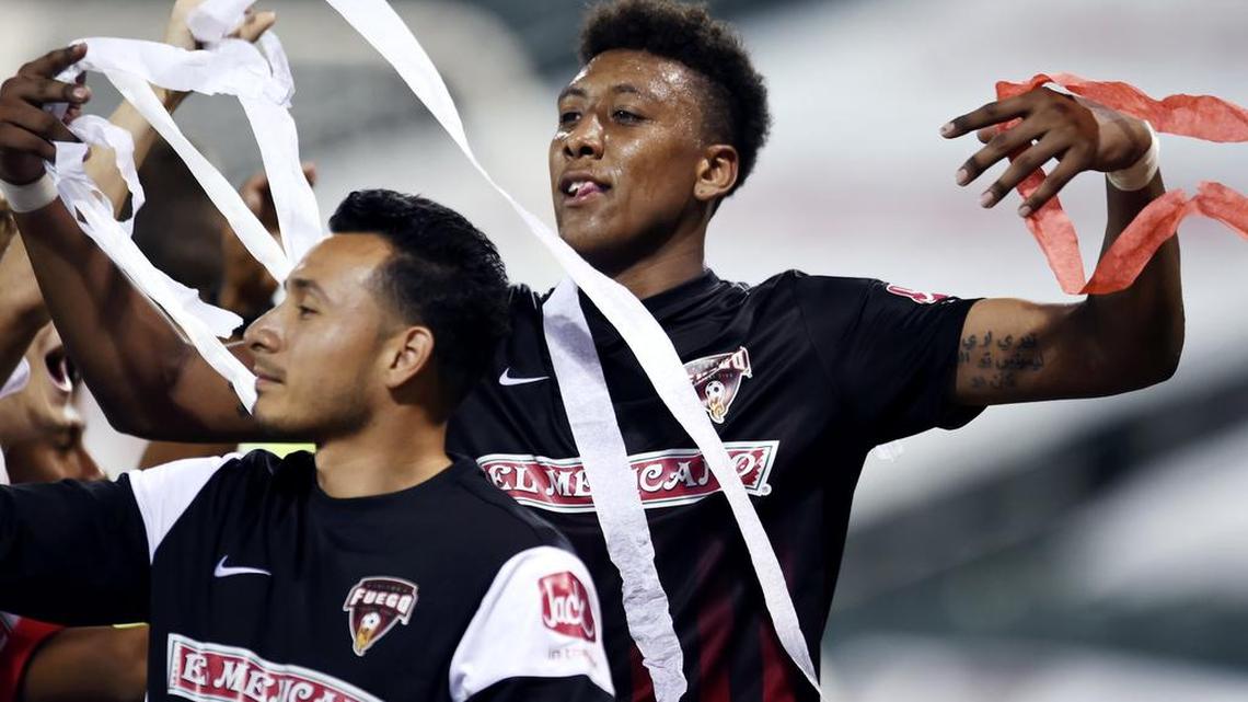 Christian Chaney of the Fuego, right, poses with others as streamers fall onto the team as players celebrate a 1-0 win over Southern California Seahorses on July 2, 2016 in Fresno, Calif.