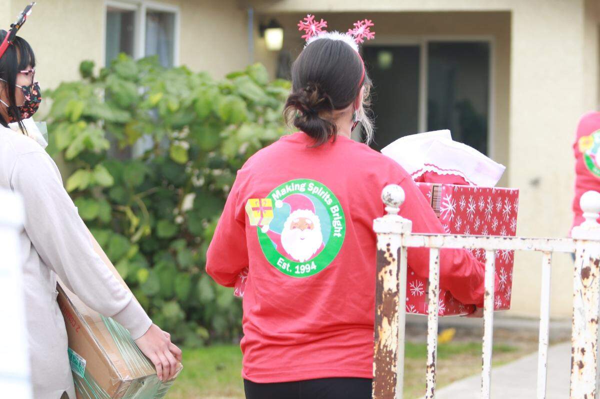 Staff from the Fresno Economic Opportunities Commission Sanctuary and Support Services delivered holiday cheer at the doorstep of the 25 low-income families selected from Columbia Elementary just west of downtown Fresno for this year’s Making Spirits Bright operation on Saturday morning.