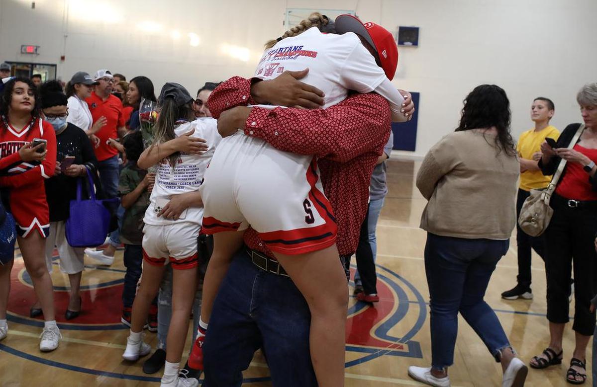 Strathmore High senior guard Jazmine Soto loses gets a bear hug from her father, Antonio Soto, after her team’s 73-60 win over Corcoran to win the CIF Central Section Division V girls basketball championship on June 10, 2021.