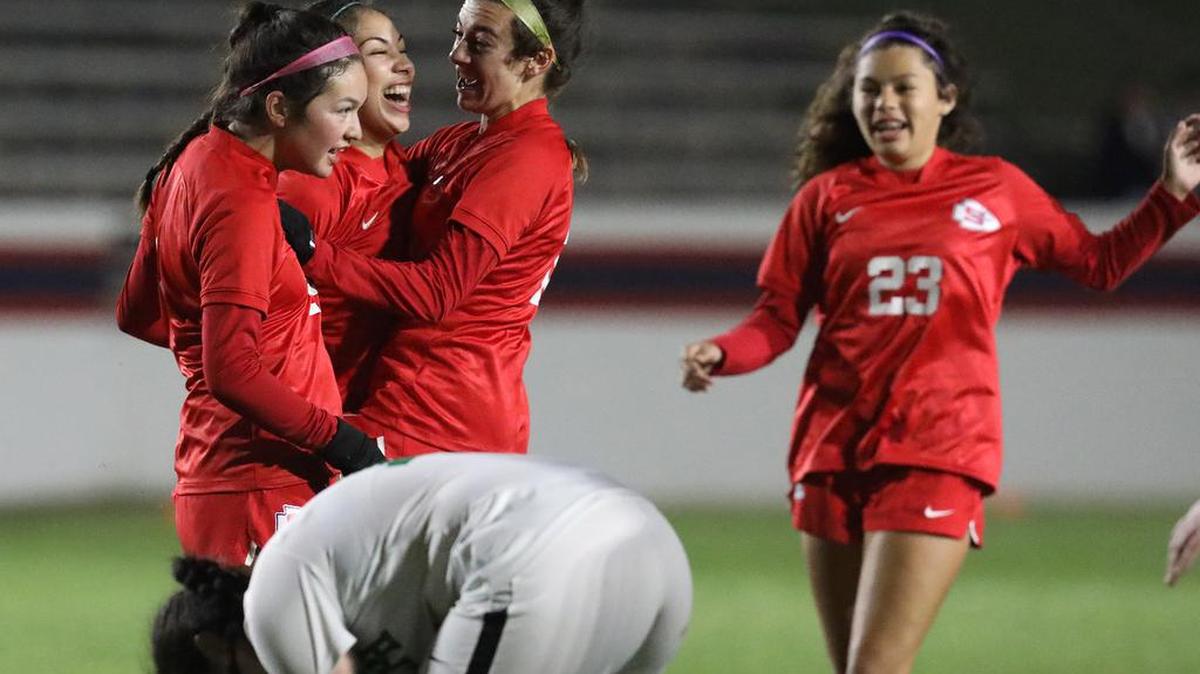 Sanger High senior Karina González (second from left) is all smiles after scoring the CIF Central Section Division II quarterfinal match's first goal in the final 9 minutes of play against St. Joseph's.