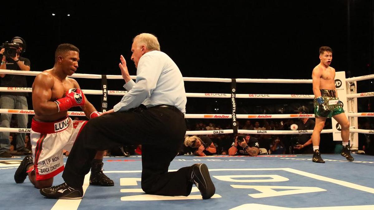 Marc Castro of Fresno walks away while referee Jack Reis counts out Angel Luna at Chukchansi Park on Oct. 16, 2021.