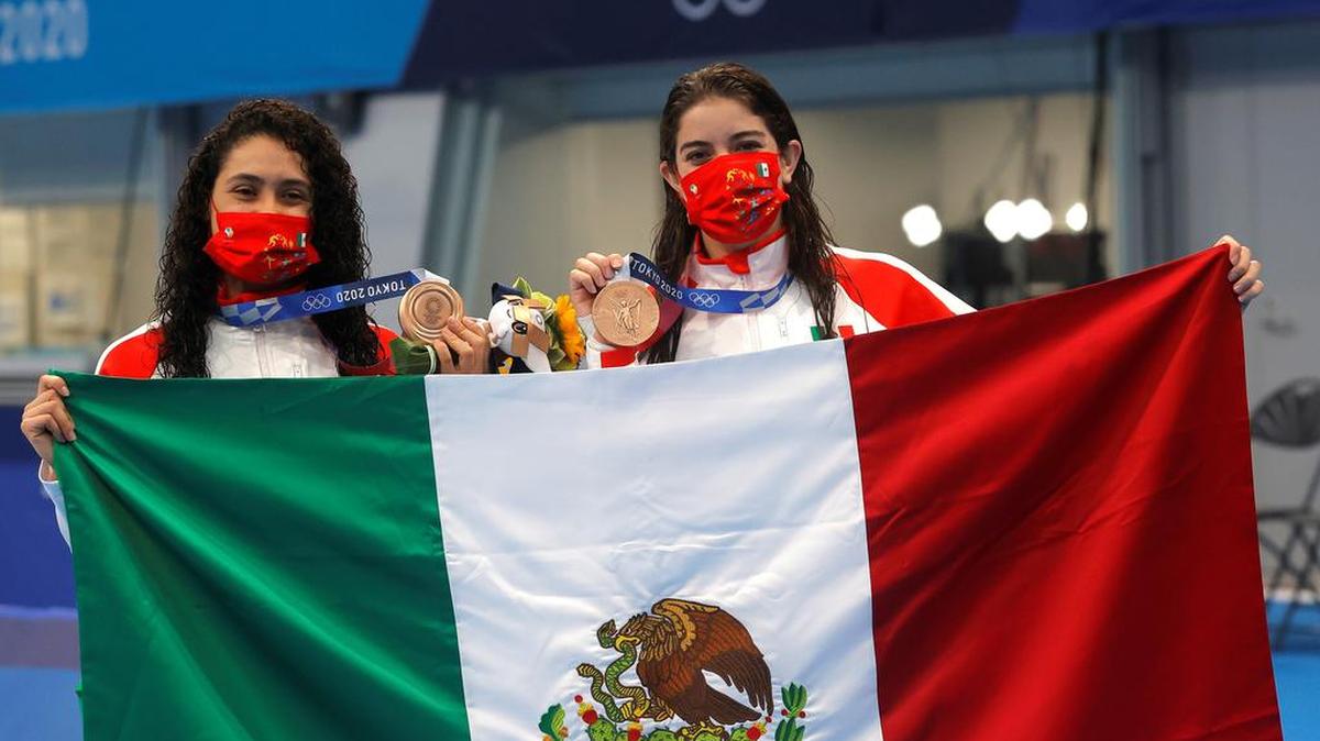 The bronze medalists Gabriela Agúndez García and Alejandra Orozco Loza of México celebrate after the diving women synchonized 10m platform final of the Tokyo 2020 Olympic Games at the Nippon Budokan arena in Tokyo.