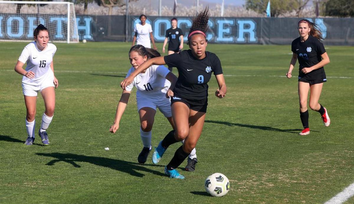 Clovis North senior forward Cadence Whitley breaks away from Bakersfield High defender Sarah Vásquez during a CIF Central Section girls Division I soccer match.