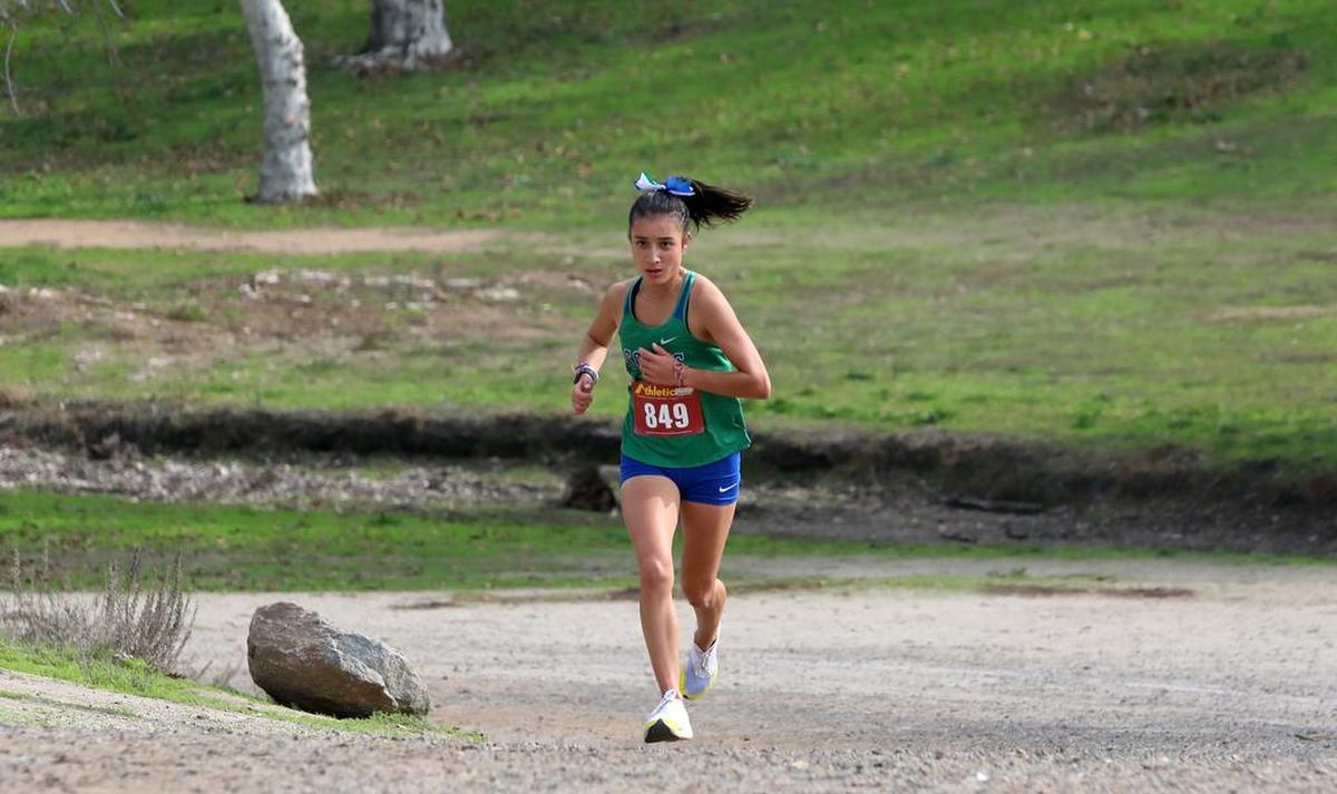 Highland High School sophomore Mía Torrecillas was all alone with less than a mile to go in the CIF Central Section girls Div. III race. She won in 18:24.14 to lead the Bakersfield-based team to the team title.