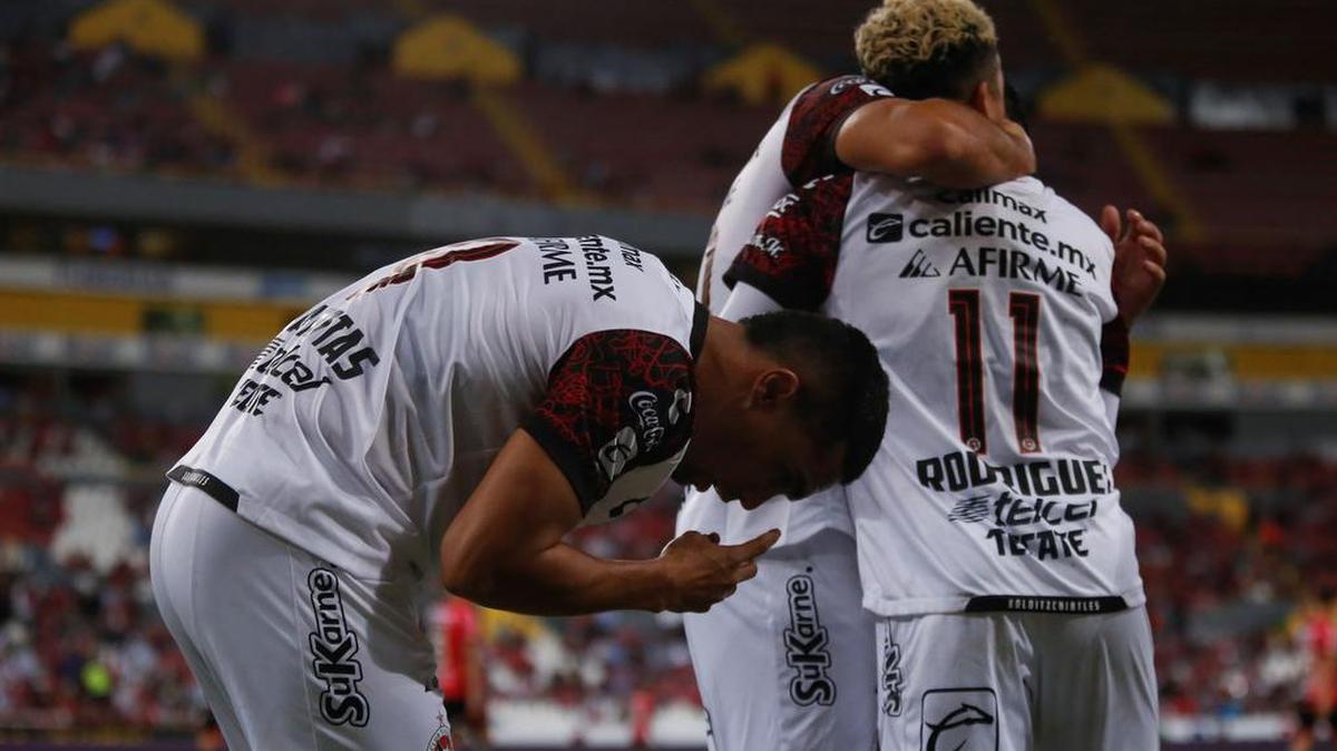 Mauro Manotas (i) de Xolos celebra una anotación ante Atlas hoy, durante un partido de la jornada 16 del Torneo Apertura 2021 del fútbol mexicano disputado en el Estadio Jalisco en Guadalajara, Jalisco.
