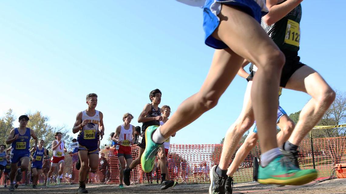 Participants in the boys Division V race approach the mile mark at Woodward Park on Nov. 27, 2021.