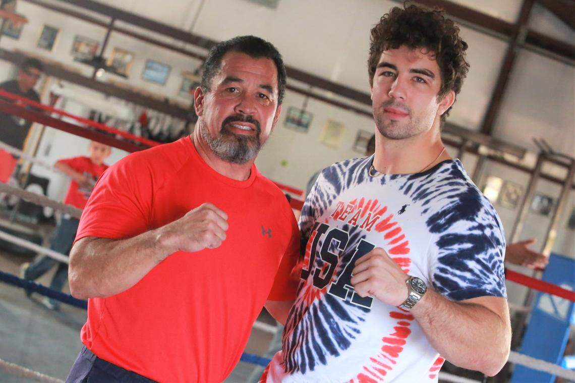 Olympic medalist Richard Torrez Jr. (right) posed for a photo with his father Richard Torrez Sr. inside the Tulare Athletic Boxing Club on Aug. 18. Torrez Jr. took home the Silver medal representing the United States during the men’s super heavyweight at the 2020 Summer Olympics, Sunday, Aug. 8, 2021, in Tokyo, Japan.