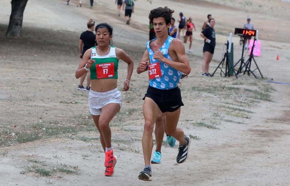 Alma Delia Cortes of México leads a group of runners that includes Seth Frazier at the Miguel Reyes 5K at Woodward Park on July 31, 2022.