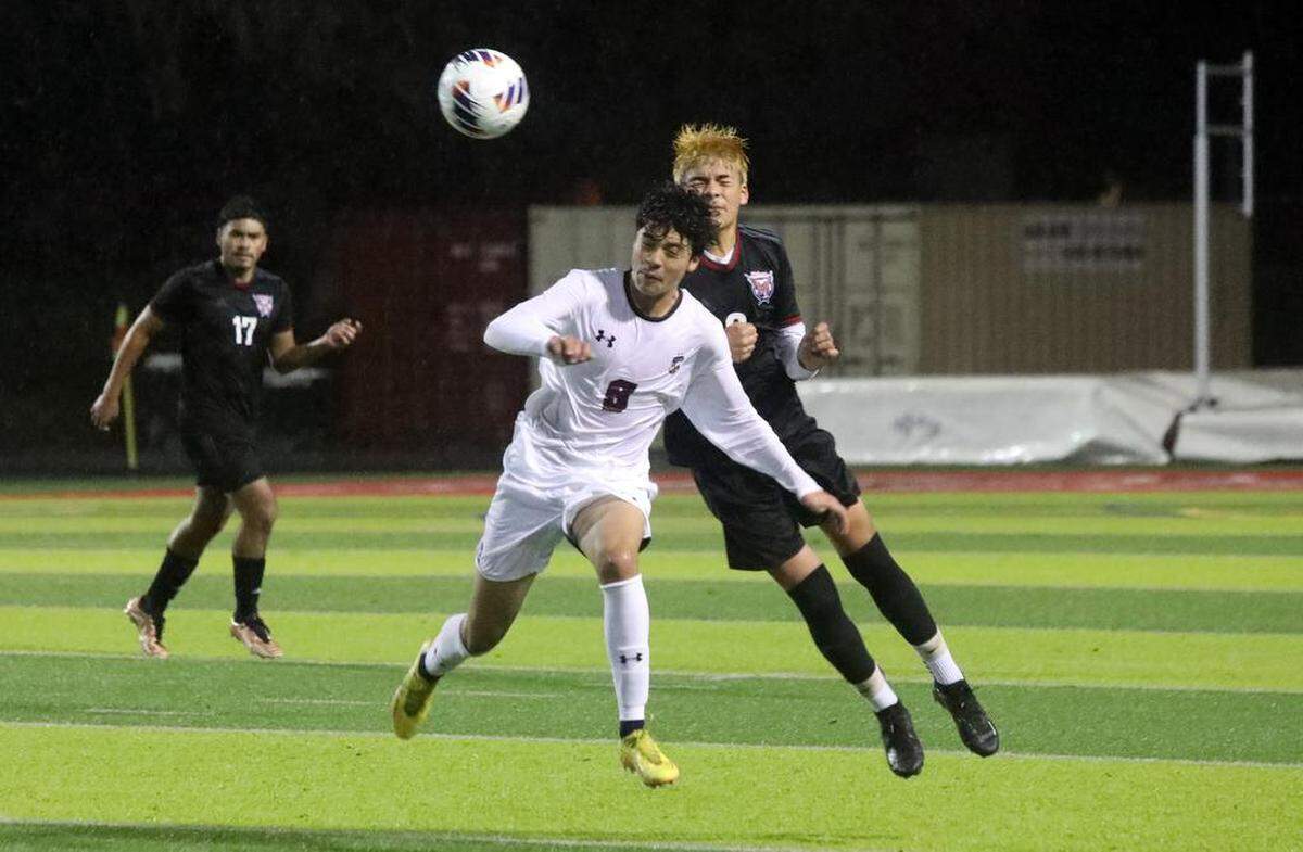 Chávez High senior Silverio Alonso gets defended by McLane High sophomore Diego Méndez during the CIF Central Section Division III boys soccer championship on Feb. 24, 2023. McLane won 3-2 in overtime over Chávez High.