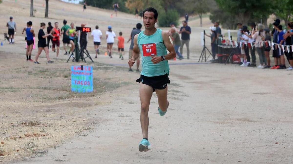 Diego Estrada of Salinas gets past the 2-mile mark at the Miguel Reyes 5K at Woodward Park on July 31, 2022. He won the overall title in a course-record 14:14.57.