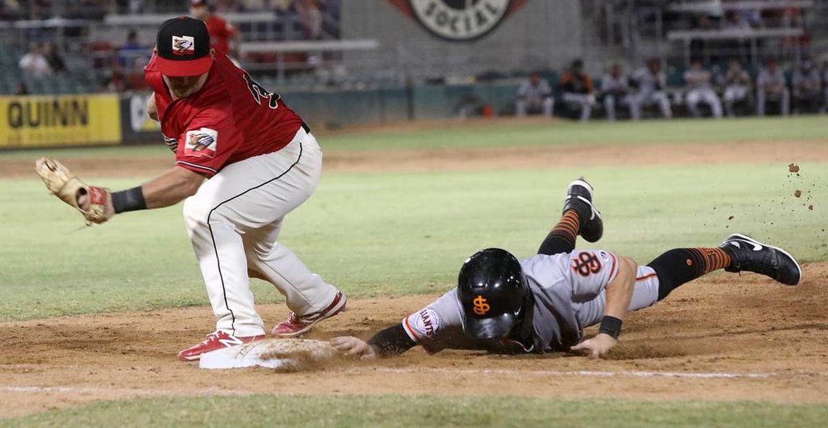 San Jose Giants baserunner Jimmy Glowenke slides safely back to first ahead of tag by Fresno Grizzlies first baseman Colin Simpson.