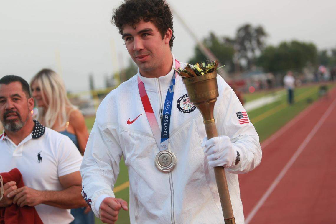 The ceremony at the stadium on Aug. 21 included Richard Torrez Jr. lighting the Olympic flame replica with a torch handed to him by his father Richard Torrez Sr.