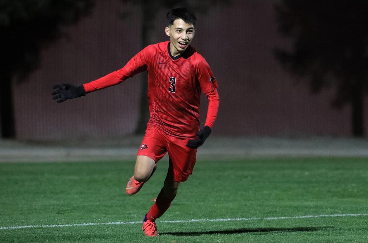 Kerman High sophomore Jonathan Velásquez celebrates his game-winning goal with 4½ minutes left against Madera High in a CIF Central Section Division III soccer match.