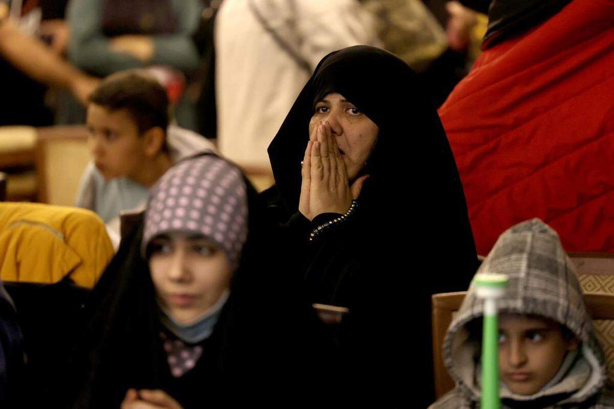 Iranians react after Iran lost the FIFA World Cup 2022 match between Iran and the USA, at Milad Hall in Tehran, Iran.
