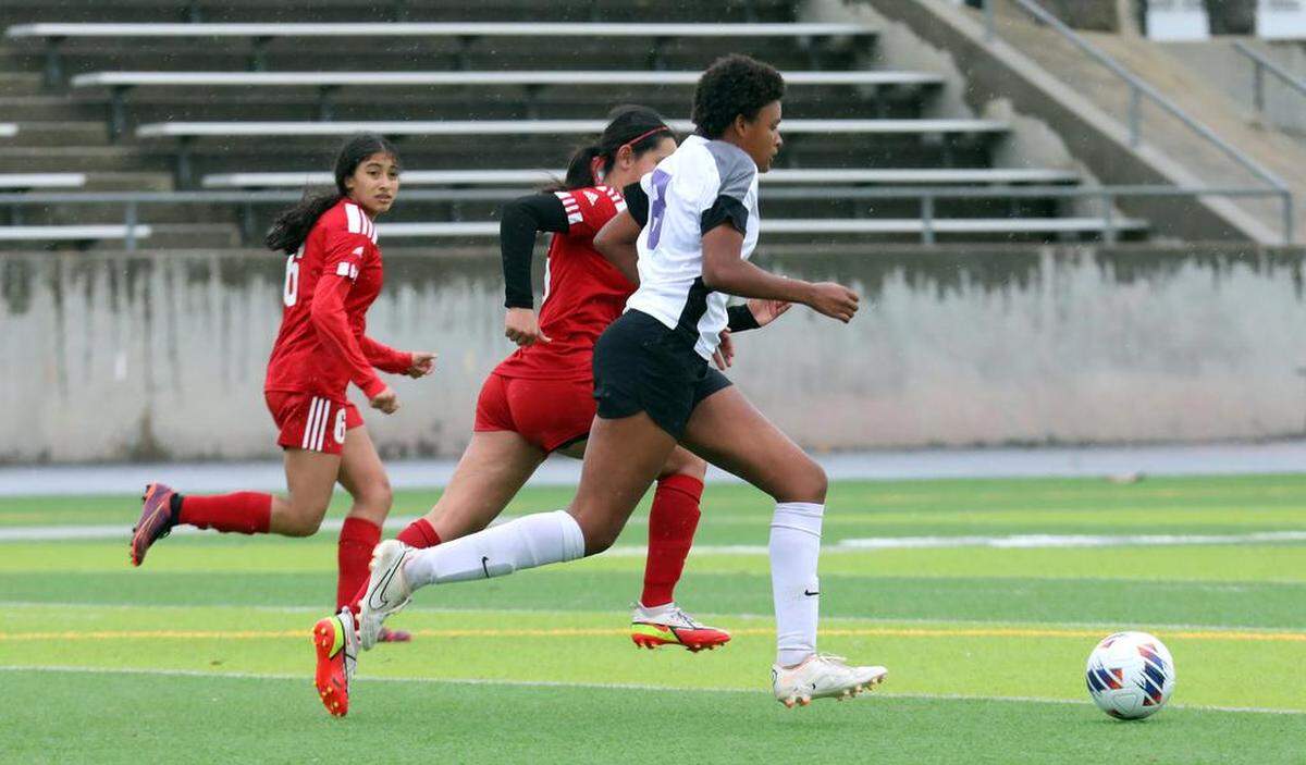 Desert High’s Camryn Freeman, who scored two goals, draws two McLane High defenders during a CIF Central Section Division VI semifinal on Feb. 27, 2023. McLane won, 6-2.
