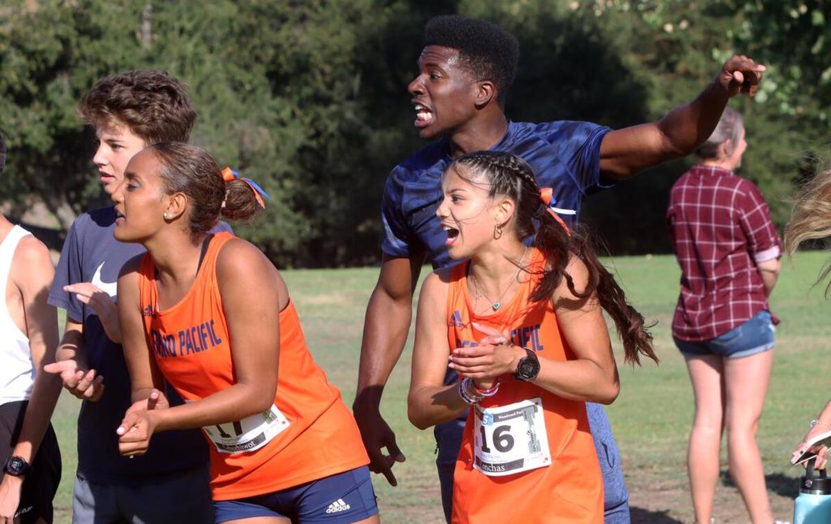 Spectators scream support for Fresno Pacific runners at the end of the men's race in the Sept. 3, 2022 Seawolf Invitational at Woodward Park.