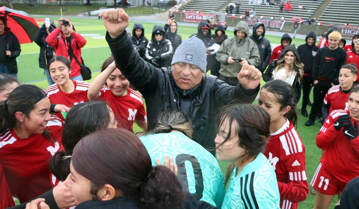 McLane High girls soccer head coach David Álvarez celebrates his team’s 3-0 win over Rosamond High to capture the CIF Central Section Division VI championship in rain and wind at McLane High Stadium on Feb. 28, 2023.