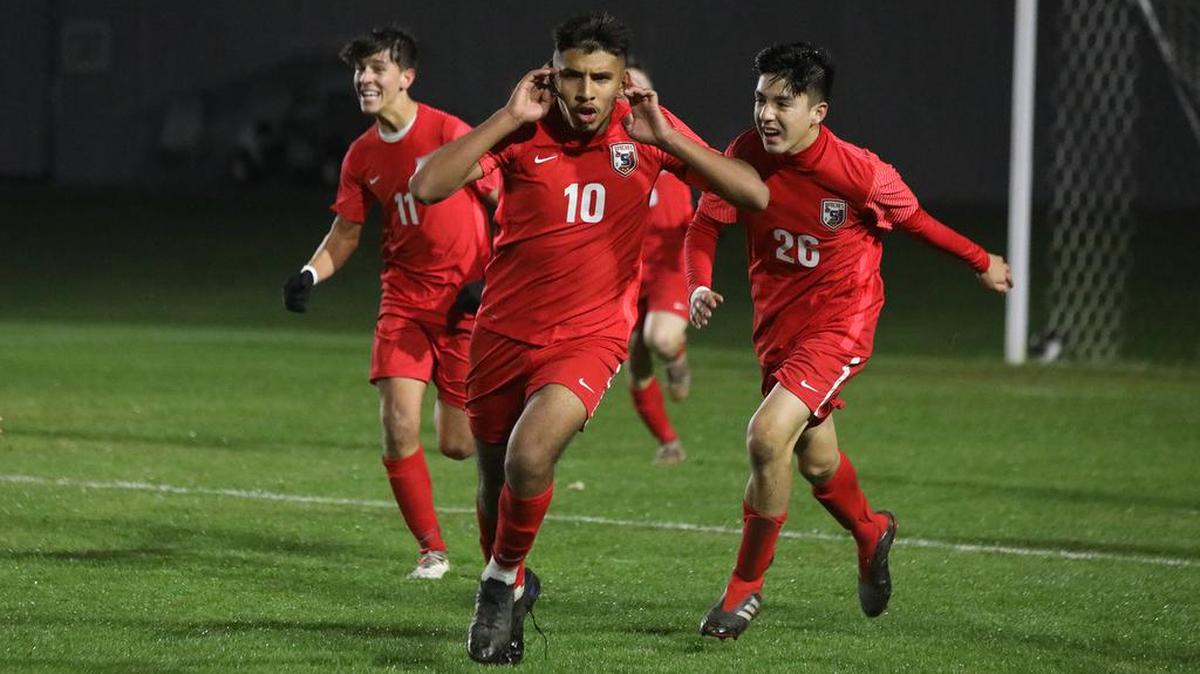 Sanger High midfielder Julio Hernández and his teammates celebrate his goal in overtime that gave the Apaches a 3-2 lead against Clovis East.