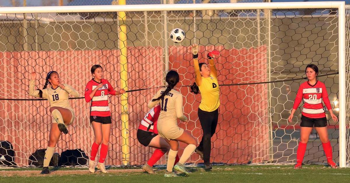 Kerman High sophomore goalkeeper Yazmine Gastélum knocks a corner kick ball away in the first half of a Northern California Division IV regional match on March 1, 2022.