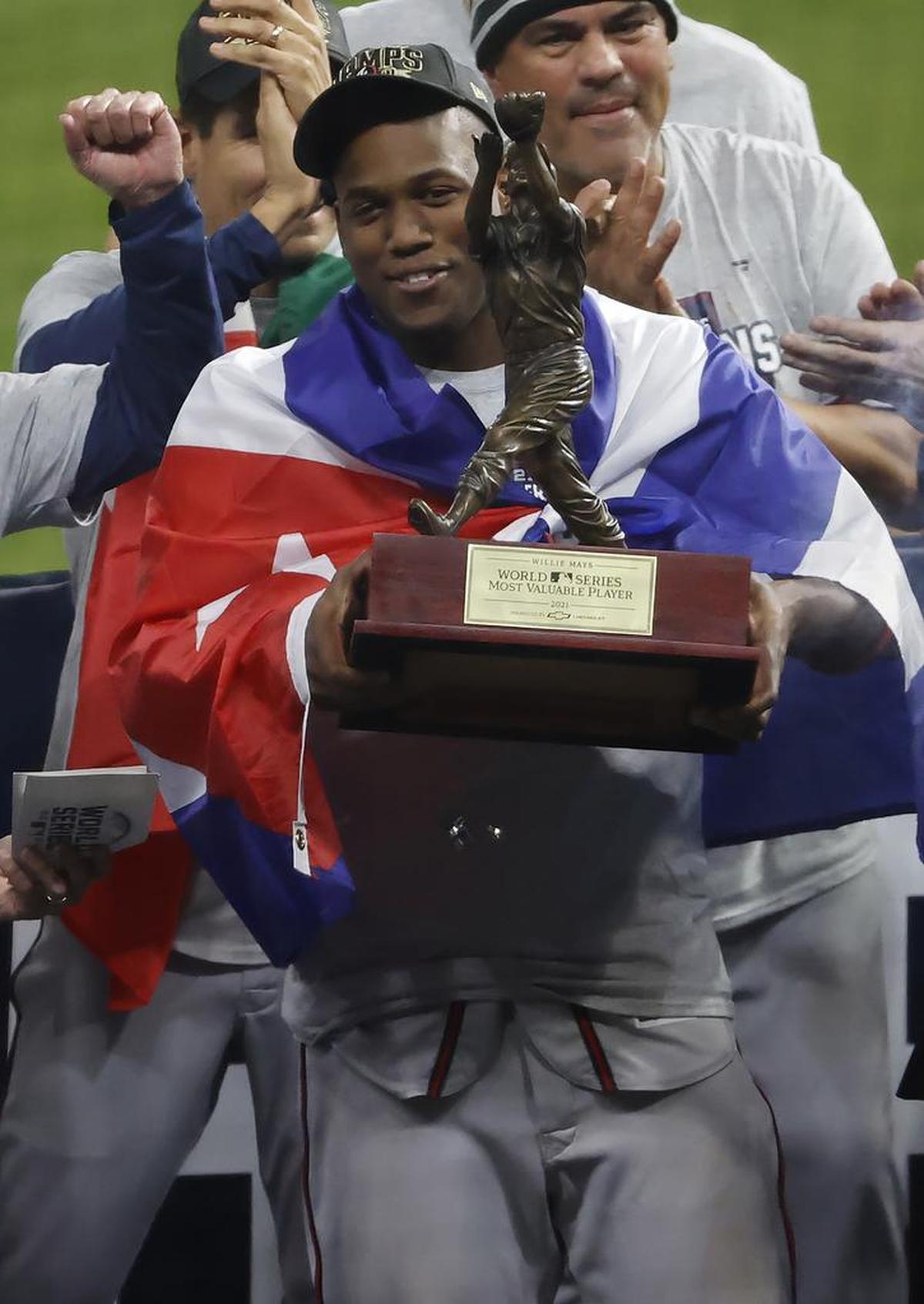 Atlanta Braves player Jorge Soler hoists the MVP Trophy after the Braves defeated the Houston Astros in game six of the Major League Baseball World Series to win the World Series 4 games to 2 at Minute Maid Park in Houston, Texas.