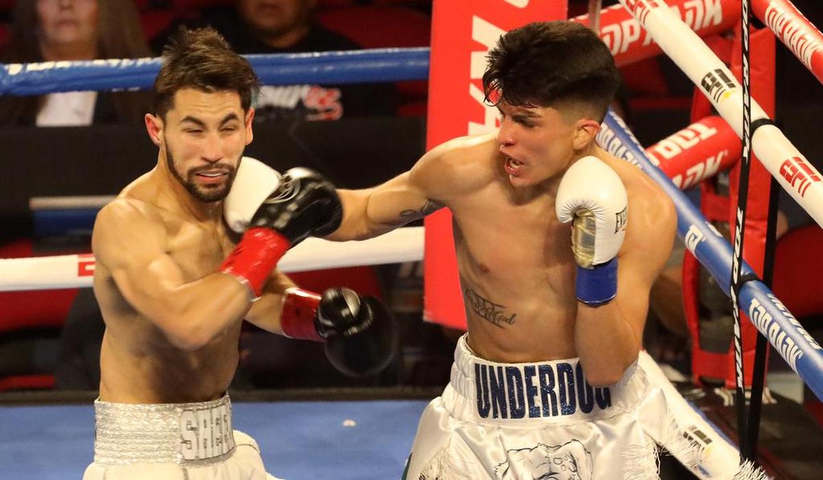 Charlie Sheehy of Brisbane absorbs a left Johnny Bernal of Denver in a lightweight bout at the Save Mart Center on March 4, 2022.
