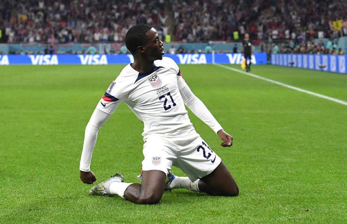 Timothy Weah of the USA celebrates after scoring the opening goal during the FIFA World Cup 2022 group B soccer match between the USA and Wales at Ahmad bin Ali Stadium in Doha, Qatar.