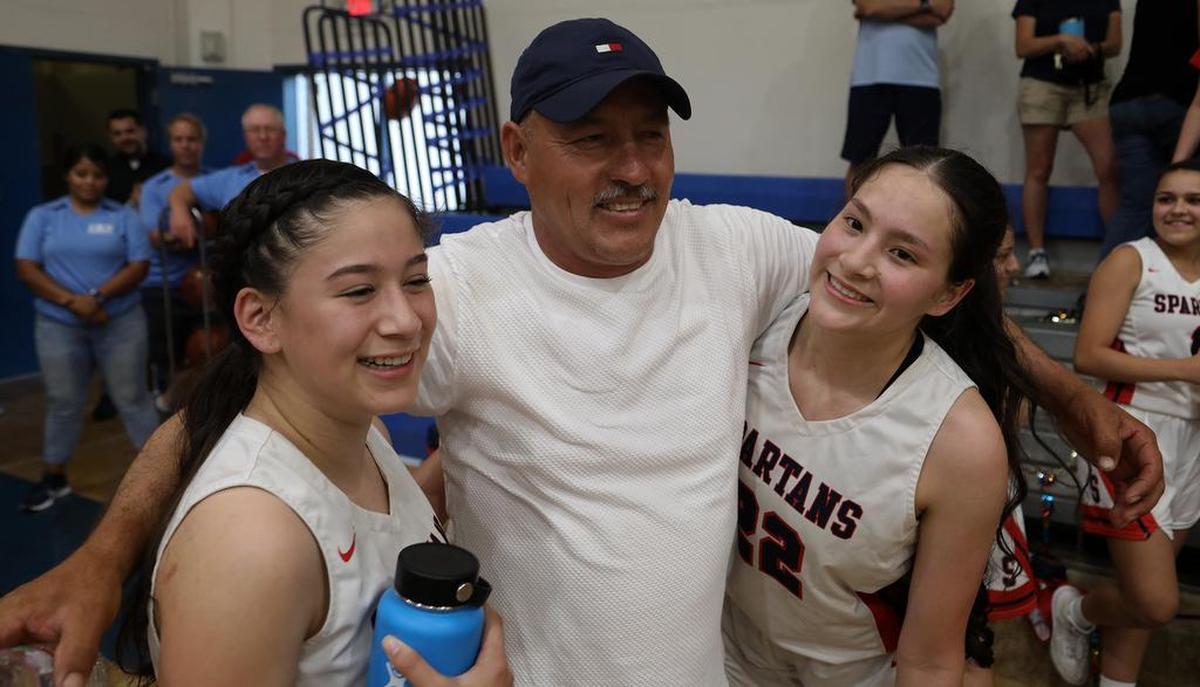 Israel Gutiérrez celebrates with daughters Yvette and Joseli after they helped Strathmore High capture the CIF Southern Section Division V-AA championship with a 63-54 win over Fallbrook High on June 19, 2021.