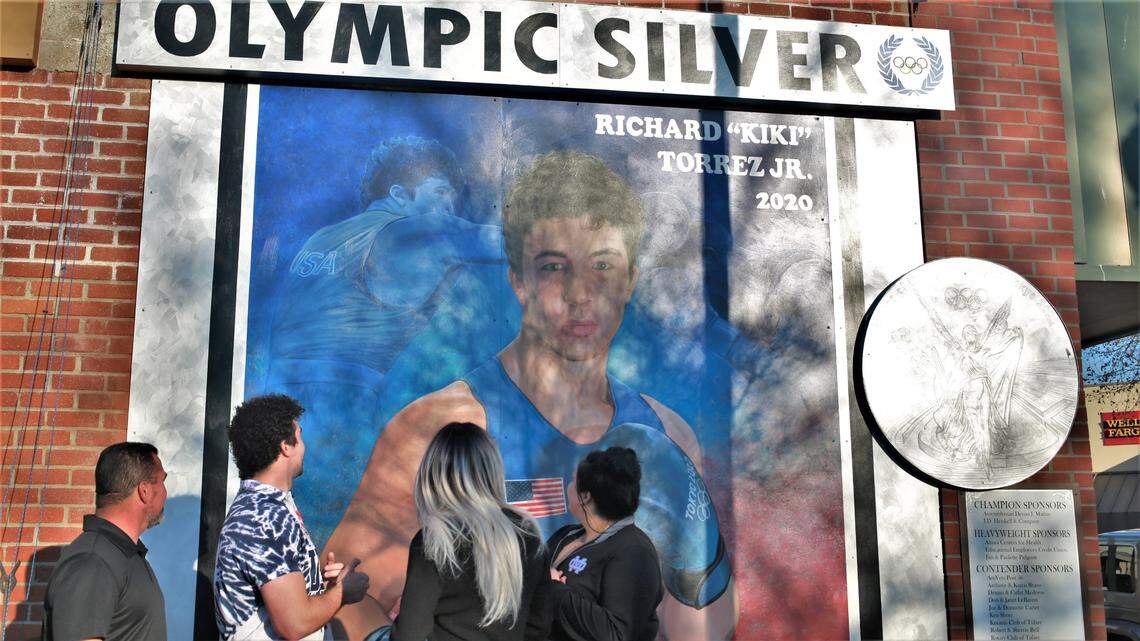 The Tulare Chamber of Commerce unveiled the mural for Richard ‘Kiki’ Torrez Jr. on the chamber’s building wall next to the murals of Olympians Bob Mathias and Sim Iness on Feb. 4, 2022, in downtown Tulare. It also unveiled the rendering of the additional mural that is slated to be completed sometime in the spring at the boxing club.
