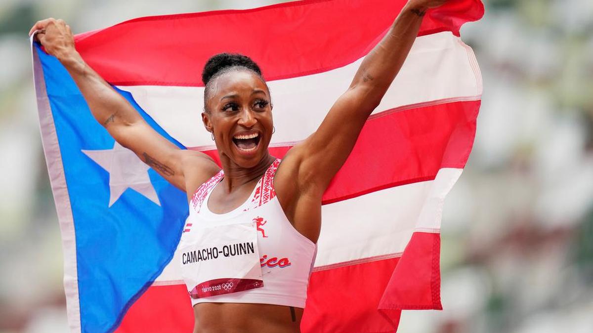 Jasmine Camacho-Quinn of Puerto Rico celebrates winning the Women’s 100m hurdles final at the track and field events of the Tokyo 2020 Olympic Games at the Olympic Stadium in Tokyo.