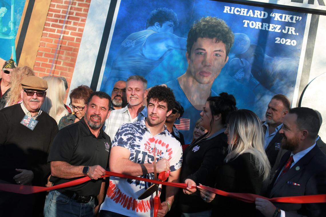 The Tulare Chamber of Commerce unveiled the mural for Richard ‘Kiki’ Torrez Jr. on the chamber’s building wall next to the murals of Olympians Bob Mathias and Sim Iness on Feb. 4, 2022, in downtown Tulare. It also unveiled the rendering of the additional mural that is slated to be completed sometime in the spring at the boxing club.