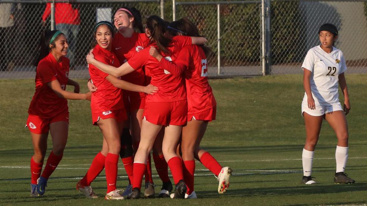Sanger High senior Diana García (tall player in middle) celebrates her goal with teammates during their 2-0 win over San Luis Obispo for the Central Section Divisino II championship on Feb. 26, 2022.