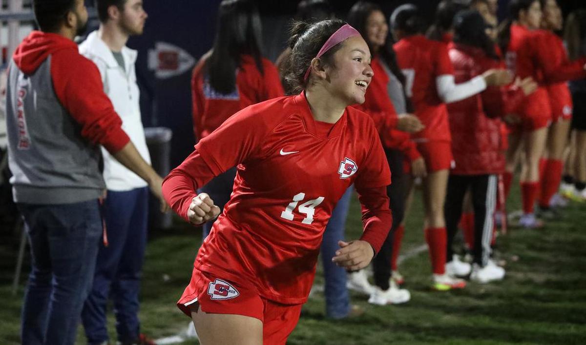 Sanger High senior Diana García is all smiles after being introduced prior to the CIF Central Section Division II match against St. Joseph's.