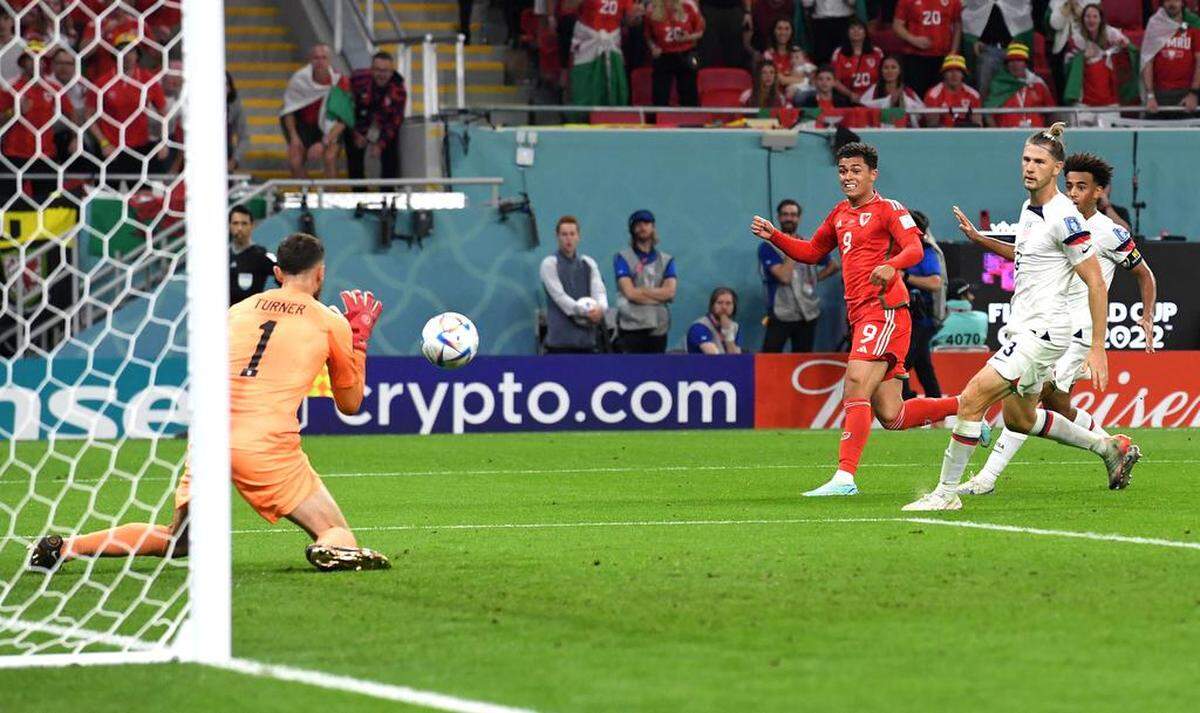 USA goalkeeper Matt Turner saves a shot by Brennan Johnson of Wales during the FIFA World Cup 2022 group B soccer match between the USA and Wales at Ahmad bin Ali Stadium in Doha, Qatar.
